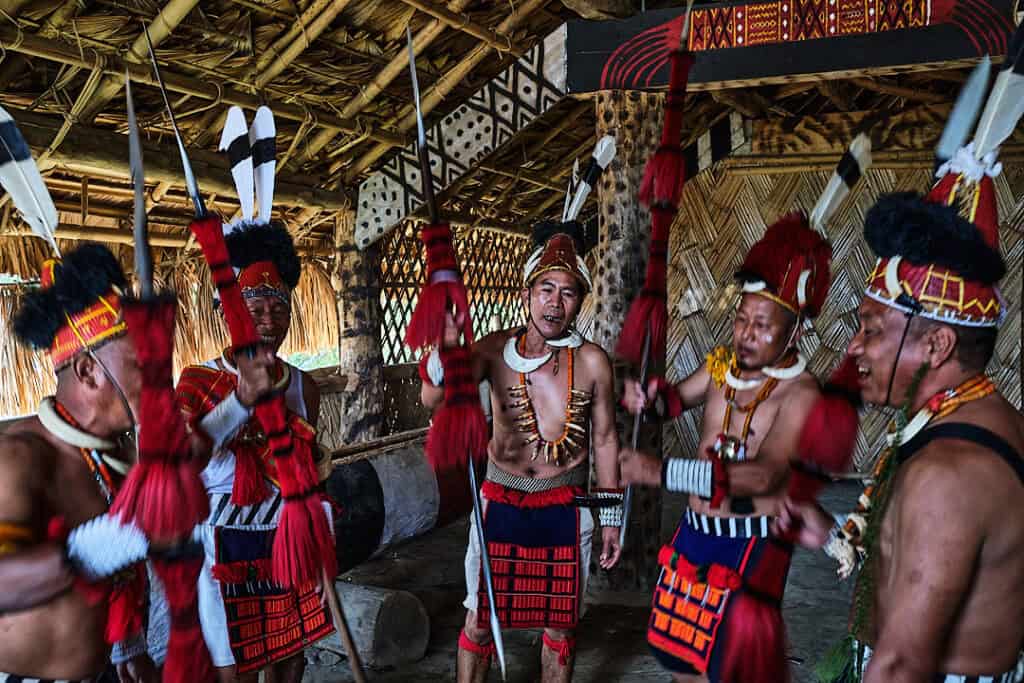 Konyak man preparing for the Aoling Festival, adjusting traditional attire and ornaments on the morning of the main celebration.