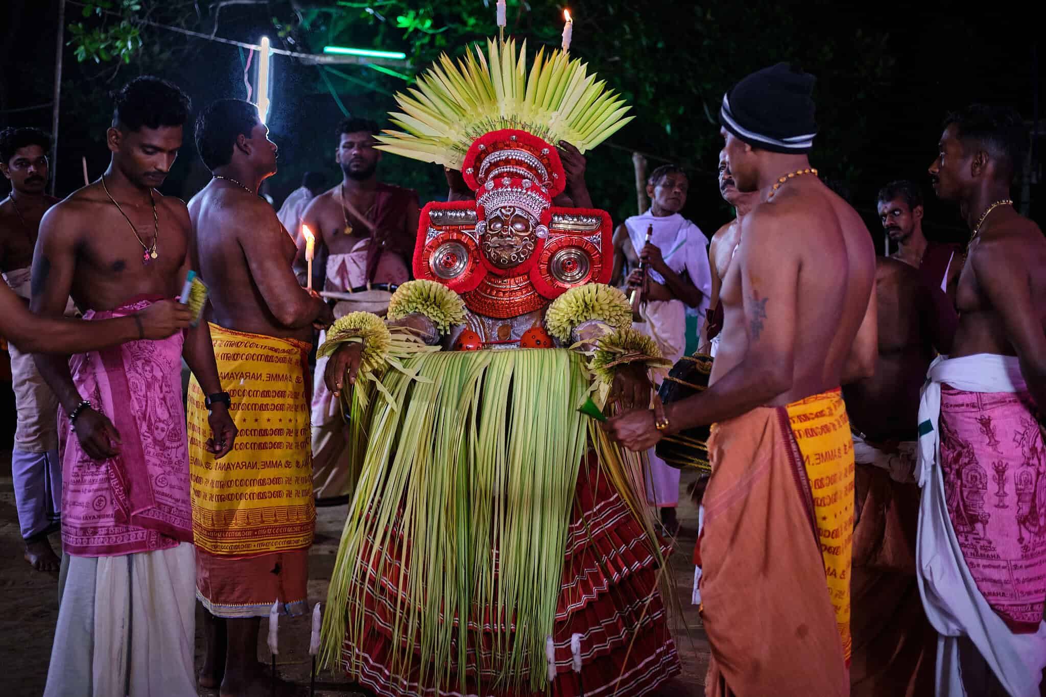 Standing tall amidst the chanting crowd, the Theyyam is now the undisputed center of the universe.