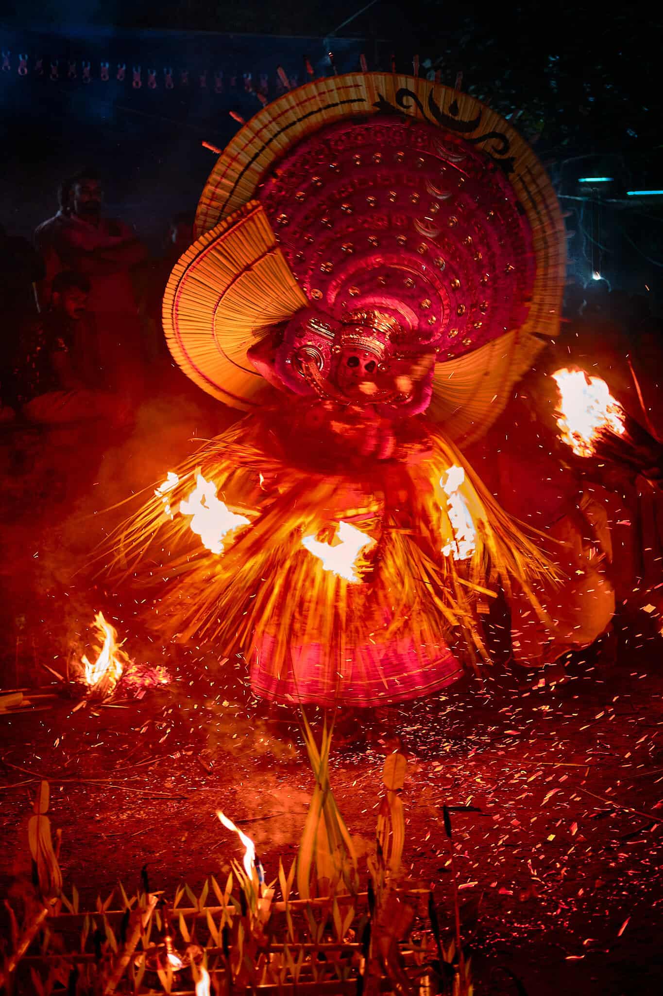 Theyyam - Enveloped in a shroud of smoke and light, the Theyyam becomes a literal force of nature, moving with a speed that defies the camera’s lens.