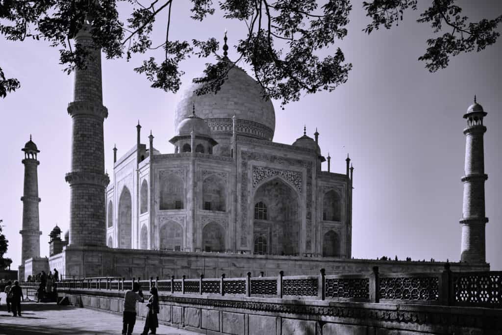 Black and white photograph of Taj Mahal highlighting its symmetry and architectural details.